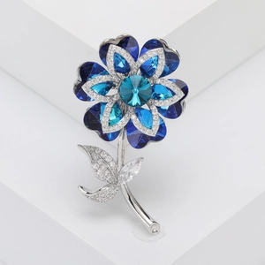 Detailed macro view of an elegant blue crystal flower brooch with silver plating