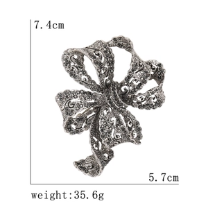 Vintage style ribbon bow brooch with black rhinestones in antique silver finish
