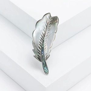 Elegant natural mother-of-pearl feather brooch with abalone shell inlay on white blocks