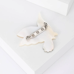 Elegant natural mother of pearl bird brooch with secure silver-tone metal pin closure