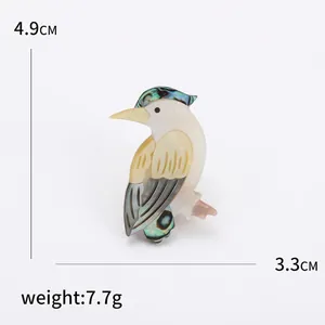 Elegant parrot brooch crafted from natural shell and abalone inlay, measuring 4.9cm by 3.3cm