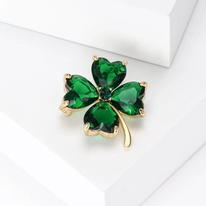 Macro shot of high-end crystal four-leaf clover brooch with green heart-shaped gems