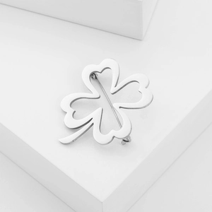 Detailed back view of silver four-leaf clover brooch showing secure clasp and metal texture