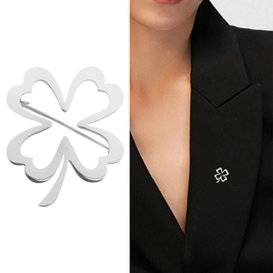 Minimalist silver stainless steel hollow four-leaf clover brooch on a black blazer