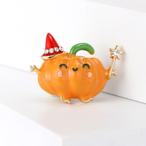 Detail of cute Halloween pumpkin brooch with orange enamel finish and crystal rhinestones
