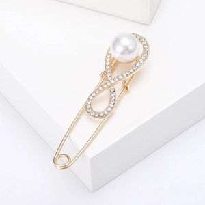 Detail of infinity symbol pin featuring sparkling rhinestones and white round pearl accent