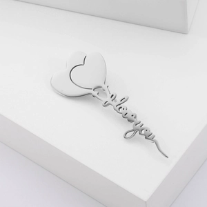 Polished silver heart brooch detail featuring elegant I love you cursive engraving