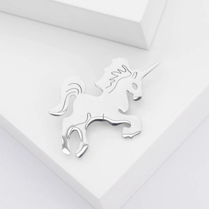 Sleek silver stainless steel unicorn brooch with a polished finish on white geometry