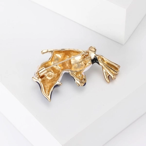 Vintage gold cat brooch with enamel finish showing the back safety pin mechanism