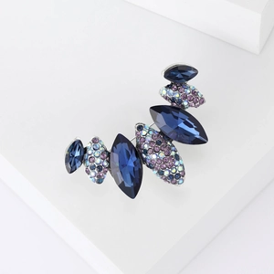 Macro detail of marquise cut navy blue crystal brooch with shimmering rhinestones
