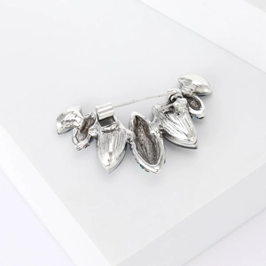 Macro view of crystal brooch back showing silver alloy base and safety pin clasp