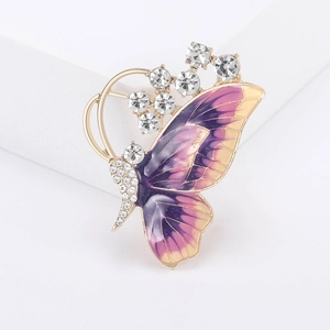 Macro detail of enamel butterfly brooch with purple gradients and sparkling rhinestones