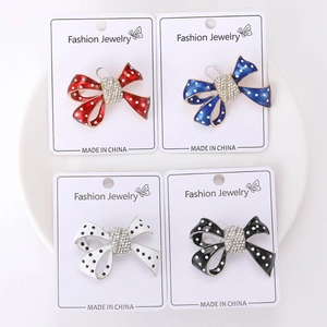 Vue détaillée de broches nœuds à pois colorés avec strass sur des cartes d'affichage