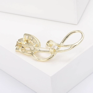 Close-up of golden tulip brooch pin showing detailed back clasp and polished metal finish