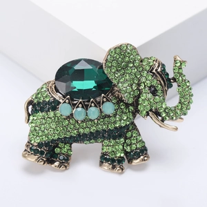 Vintage gold alloy elephant brooch with green rhinestones and emerald cut gem