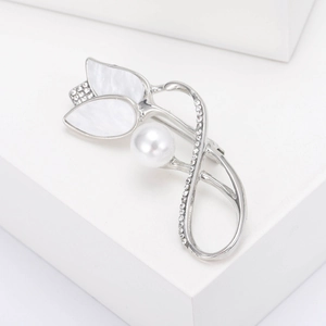 Macro detail of tulip brooch with shell petals, pearl center and pavé rhinestones