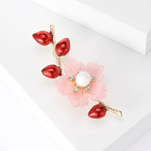 Detailansicht der rosa Blumenbrosche mit Perle und goldenem Zweig Design