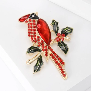 Élégante broche oiseau cardinal avec strass rouges et feuilles de houx sur socle