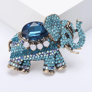 Macro shot of vintage elephant brooch with blue rhinestones and gold alloy metal