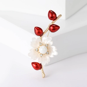 Eleganter weißer Blumenanstecker mit Goldzweigen, Perlen und roten Knospen auf weiß