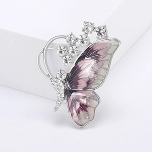 Detailed macro view of purple enamel butterfly brooch with inlaid rhinestones and silver finish