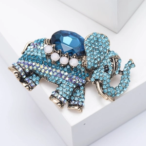 Detailed shot of retro elephant brooch with blue rhinestones and large faceted gemstone