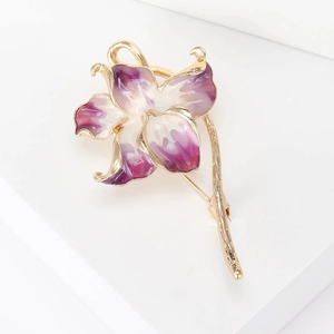 Detail of purple gradient enamel orchid brooch with elegant gold lining on petals