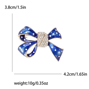 Broche nœud en émail bleu marine avec pois blancs et strass brillants 3,8x4,2cm