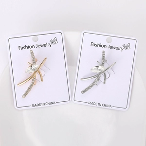 Detailed close-up of gold and silver alloy brooches with sparkling rhinestone inlay
