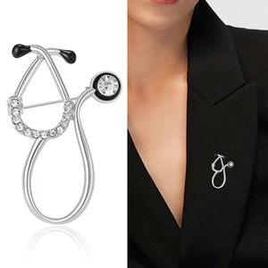 Creative silver stethoscope brooch with rhinestones shown on model and white background