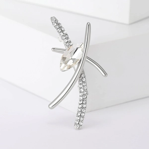 Macro detail of silver alloy brooch with marquise-cut crystal and micro-pave stones