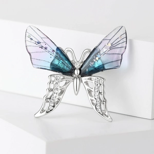 Sparkling butterfly brooch with rhinestones and purple gradient wings on white display
