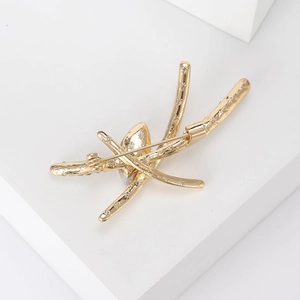 Elegant gold alloy brooch with abstract branch design and intricate floral engraving