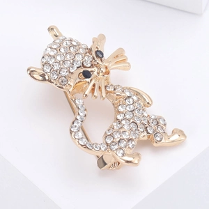 Elegant gold cat brooch with sparkling white crystals and black gem eyes in a jumping pose