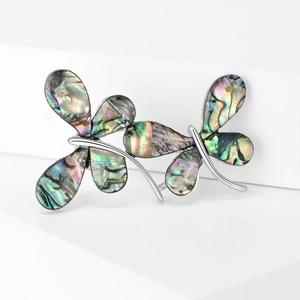 Elegant vintage dragonfly brooch with natural abalone shell inlay on white platform