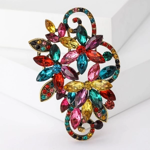 Detail view of a vintage floral crystal brooch with multicolor stones on a white stand