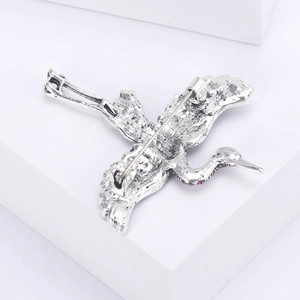 Vintage crane brooch in alloy with rhinestones, showing secure safety pin back view