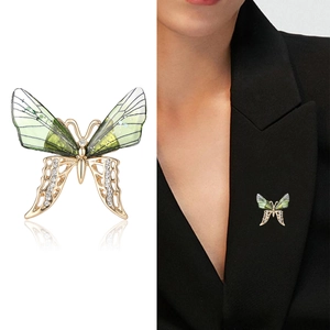 Elegant butterfly brooch with green translucent wings and sparkling rhinestones for suits