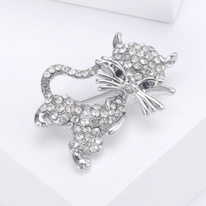 Close-up of a silver cat brooch featuring sparkling white rhinestones and black gem eyes