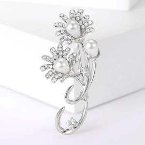 Close-up of elegant sunflower brooch with silver petals and luminous pearls