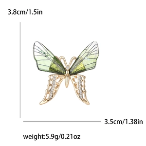 Sparkling butterfly brooch with green wings and rhinestones in gold metal finish