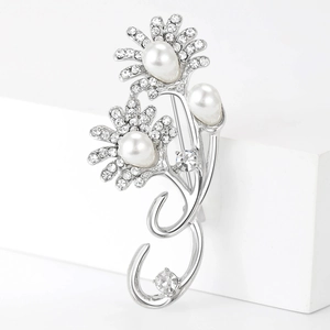 Detail view of sunflower brooch with white pearls and sparkling rhinestones in silver finish