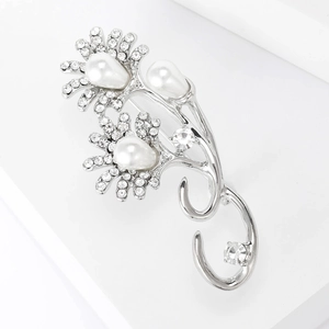 Detailed close-up of a silver sunflower brooch featuring white pearls and clear crystals