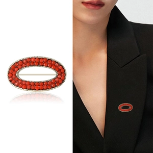 Elegant geometric oval red bead brooch with gold metal frame and model wearing view