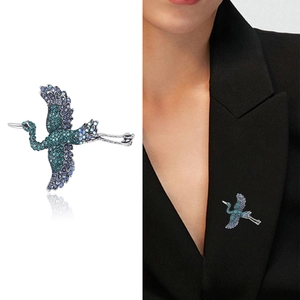 Elegant crane bird brooch with gradient blue rhinestones on a stylish business suit