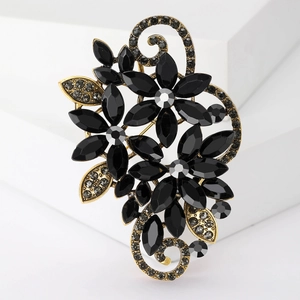 Close-up of a vintage-style flower brooch with black stones and grey crystals