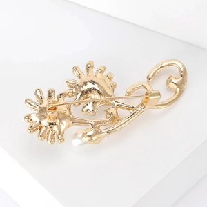 Back view of gold sunflower brooch with white pearl and secure pin closure mechanism