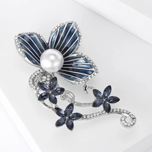 Exquisite blue enamel flower brooch with white pearl and rhinestone accents on a silver base
