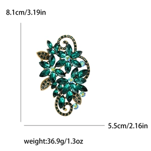 Elegant emerald crystal flower brooch in vintage bronze finish with detailed vine design