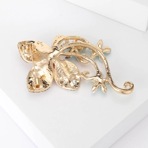 Detailed back view of gold flower brooch showing high-quality pin clasp and metal texture